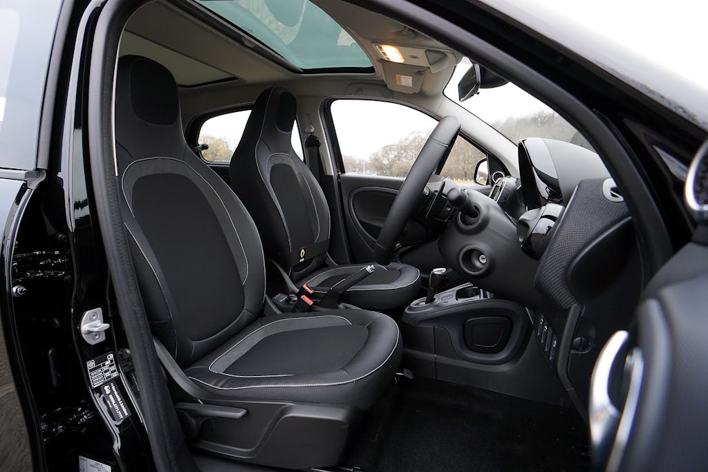 Explore a modern car's interior featuring black leather seats and advanced technology.